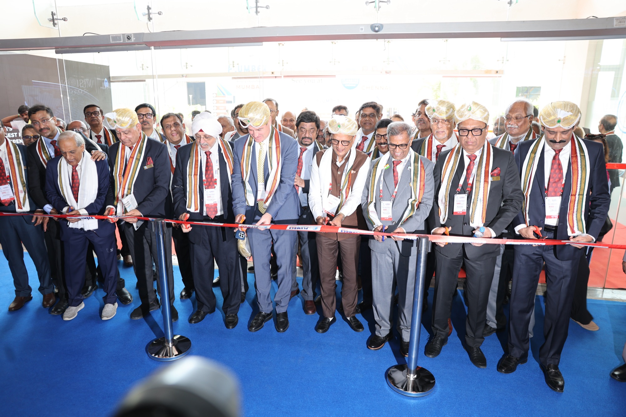 Guests and dignitaries cutting the ribbon at the PlumbexIndia inauguration